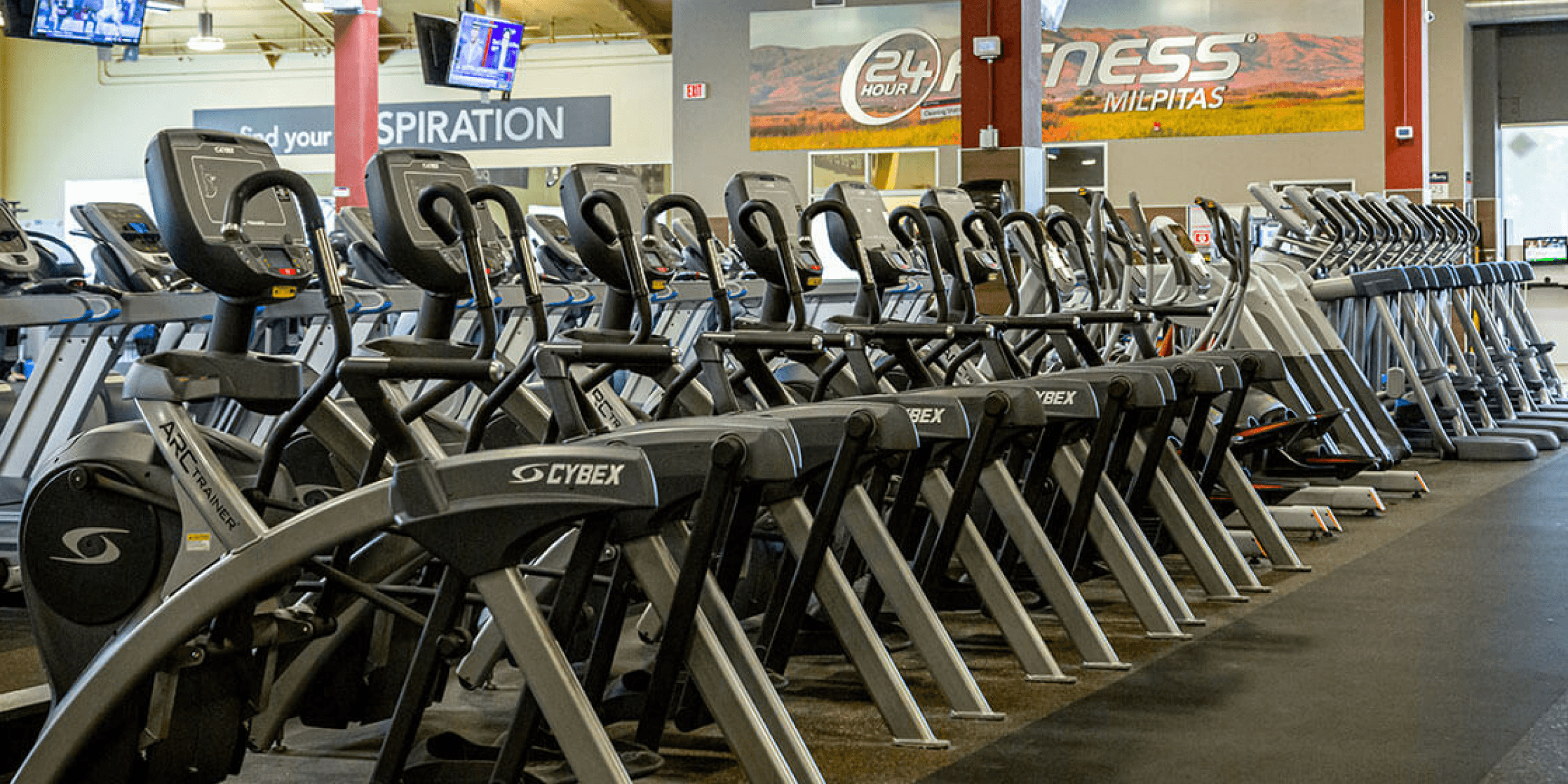 gym interior showing ellipticals and treadmills